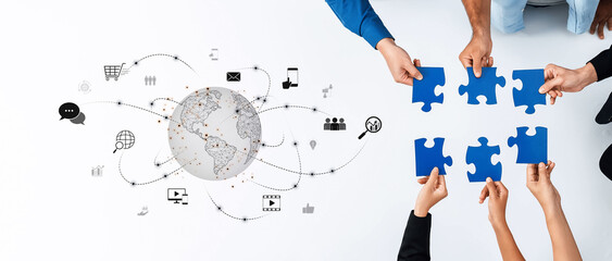 A creative concept showcasing hands holding puzzle pieces symbolizing teamwork, connected through...