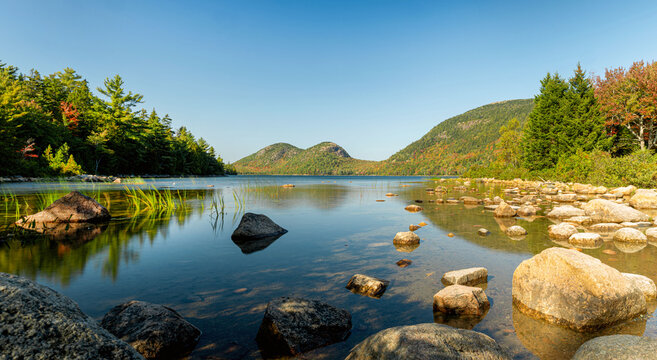 Autumn scenes at Jordan Pond with rocks at foreground