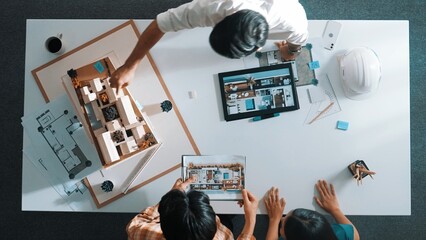Top down view of civil architect looking at project plan while present to investor at meeting...