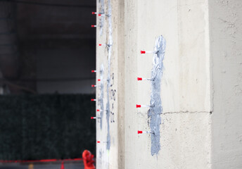 Epoxy injection crack repair on concrete foundation or bridge structure. Used for sealing and waterproofing walls. Injection ports or packers for professional concrete restoration. Selective focus.
