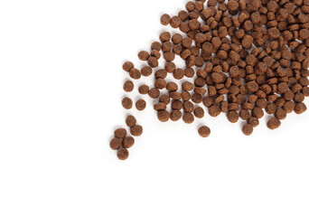 Scattered kibbles on white. Top view of dry insect protein kibble made from black soldier fly...