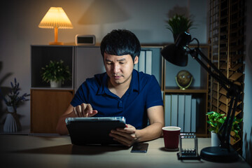 man using with digital tablet at night