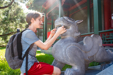 A European teenager on an excursion in the Chinese Huamin Park in Moscow.