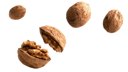 Whole and crushed walnuts close-up in the air on a white background
