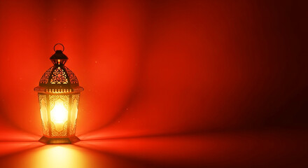 Intricate ornamental lantern is brightly glowing, casting warm light against a gradient red background