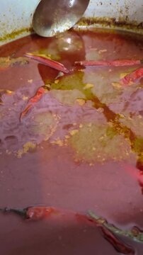 Rich Curry Gravy for Terengganu Nasi Dagang Freshly Cooked in Pot. The rich blend of coconut milk, spices, and herbs gives off an irresistible aroma, showcasing the authentic taste.