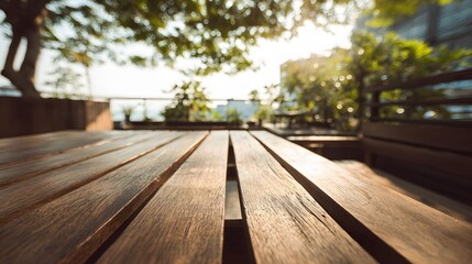 Obraz premium Wooden tabletop surface positioned low in an outdoor setting with sunlight filtering through foliage