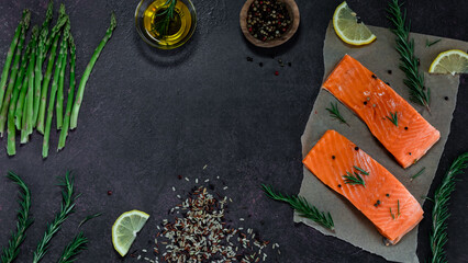 Various raw ingredients to prepare a salmon dinner with copy space in the middle