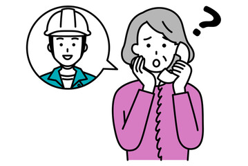 作業員に電話で相談する年配の女性