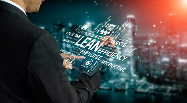 A businessman engages with digital technology highlighting lean efficiency concepts. The city background at dusk signifies modern corporate strategy and innovation. Tessel