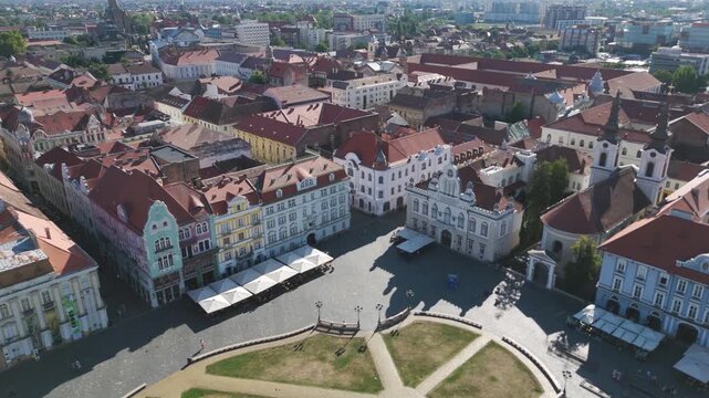 Scenic aerial view over Timisoara&rsquo;s Union Square, featuring historic buildings, religious landmarks, and architectural details.