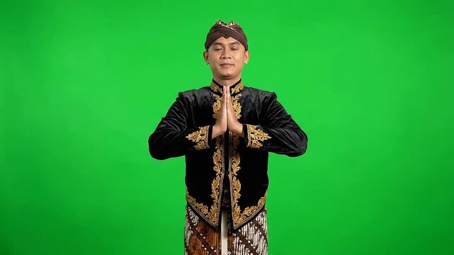 Traditional Javanese Attire Young Man Green Screen Medium Shot: Expressing Cultural Greetings in Seamless Traditional Outfit and