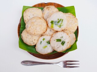 Thai coconut pudding is placed on babana leaf on a plate. Delicious Thai dessert.