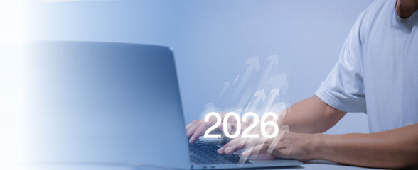 Businessman hand presenting with digital 2026, upward arrows. Futuristic concept of business...