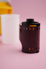 Vintage film roll on a simple pink background