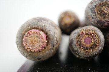 Fresh purple carrot on a wooden surface ready for cooking
