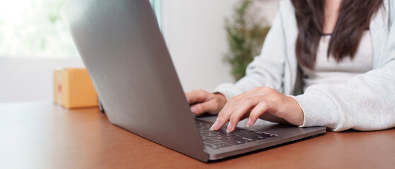 E-commerce: Woman working on laptop for online shopping business