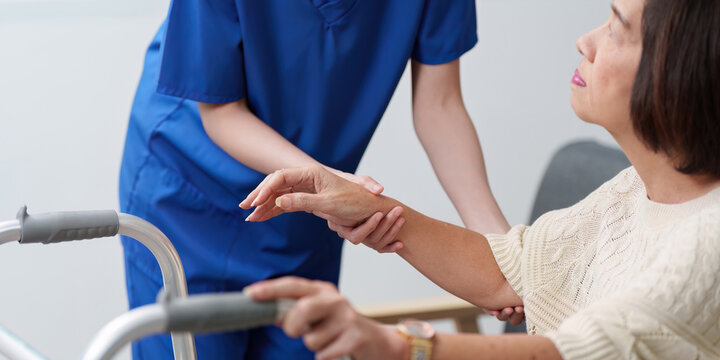 Healthcare Support. Nurse assisting elderly patient with mobility aid.