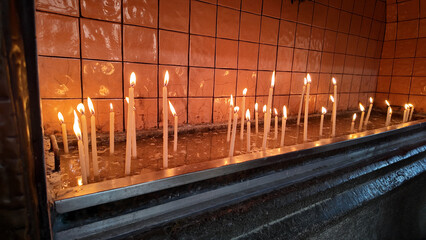 Candles lit in a serene setting for reflection and prayer