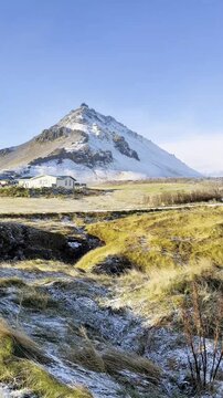 Majestic mountain backdrop behind the Bardur Snaefellsas statue in West Iceland. The volcanic landscape and misty peaks highlight the mystical beauty of the Snaefellsnes Peninsula.