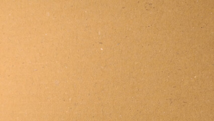Background of brown kraft paper or cardboard texture. Abstract pattern of beige rough carton, old paper sheet.