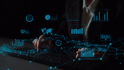 Hands typing on keyboard in a professional setting with digital analytics and data visualization...