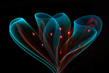 Abstract light form creating the shape of a flower made of luminous trails
