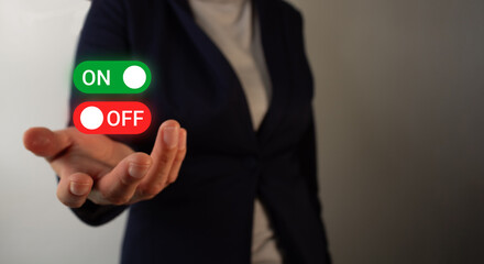 Close-up of a businesswoman's hand holding on/off buttons