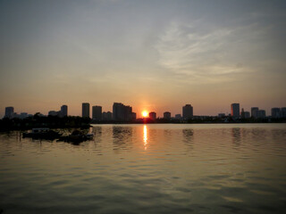 Urban Lakeside Sunset with Golden Reflection (Panoramic Skyline View) on West Lake in Hanoi, Vietnam