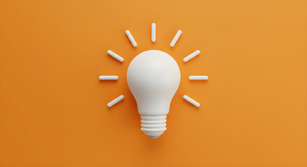Bright white light bulb illuminating on an orange background
