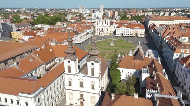 Aerial drone footage orbiting Union Square in Timisoara, Romania, highlighting the Serbian Orthodox Cathedral and the surrounding historic square.