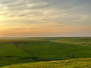 Fototapeta premium Rolling Green Hills at Sunset in the Flint Hills of Kansas