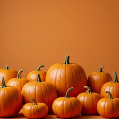 Pumpkins arranged on orange background
