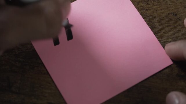 Hand writing thank you message on pink note