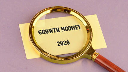 A magnifying glass is placed over a yellow paper. The words Growth Mindset 2026 are printed on the paper. It sits on a light purple background