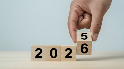 Flipping wooden blocks from 2025 to 2026, symbolizing time change