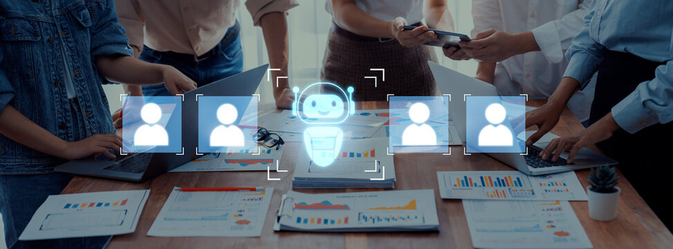 A vibrant scene capturing diverse business professionals collaborating in a modern workspace, leveraging technology and sharing insights through digital interfaces and a robot avatar. Trope - Powered by Adobe