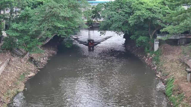The rafting boat stops in the murky water to restore the team members' strength for a crazy adventure down the city's central river.