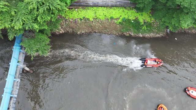 The rafting boat stops in the murky water to restore the team members' strength for a crazy adventure down the city's central river.