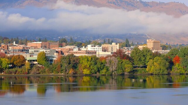 Scenic Wenatchee cityscape with low level clouds along Wenatchee river in Washington state.