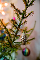 Vintage glass cone on a Christmas tree branch among tinsel and lights