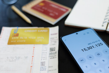 close up shot, mobile screen is showing calculator app and calculate receipt ,bills, expenses from...