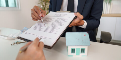 Real Estate Contract Signing. Agent explaining terms to potential buyer.