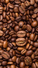 Fototapeta premium Overhead shot of roasted, dark-brown, aromatic coffee beans