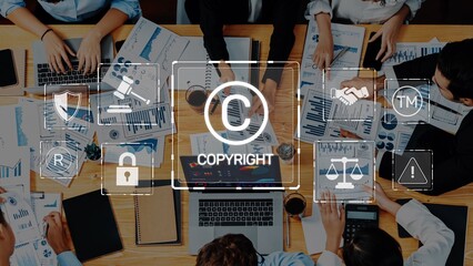 A diverse business team engages in collaboration, analyzing charts and data on laptops while...