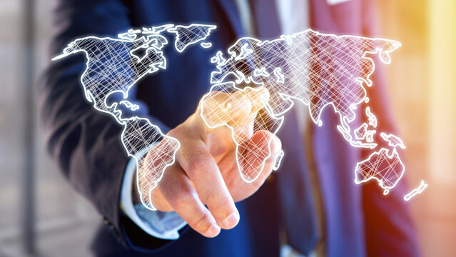 businessman holding a Hand drawn world map on a futuristic interface