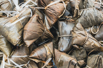 Khanom Thian or Coconut Rice Dumplings Wrapped in Banana Leaves at Street Food Stall in Bangkok