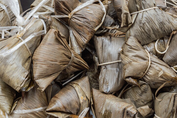Khanom Thian or Coconut Rice Dumplings Wrapped in Banana Leaves at Street Food Stall in Bangkok