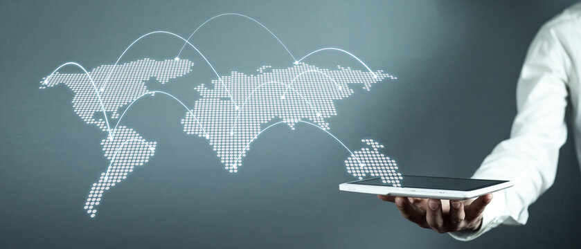 Man holding tablet with world map. Technology concept - Powered by Adobe