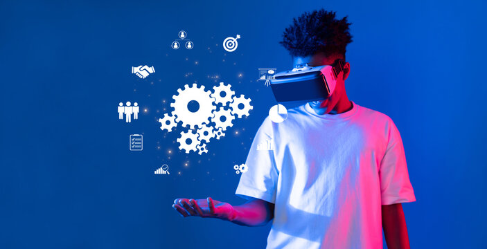 A young man wearing a virtual reality headset explores teamwork icons and business concepts, showcasing the essence of connection and innovation in a vibrant setting. XDMCP